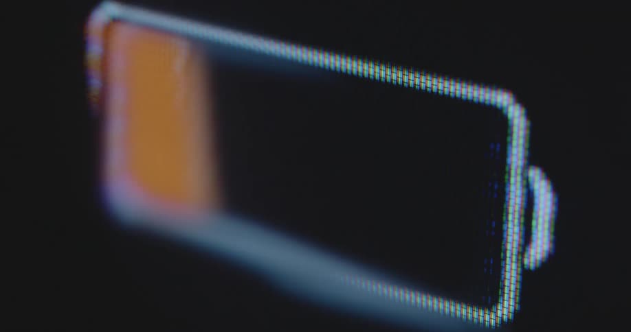 A battery icon gauge that is increasing and decreasing is displayed on a computer screen with pixels indicating the charging level of an electric car or electrical bike for an eco-friendly future with electro mobility and high energy efficiency
