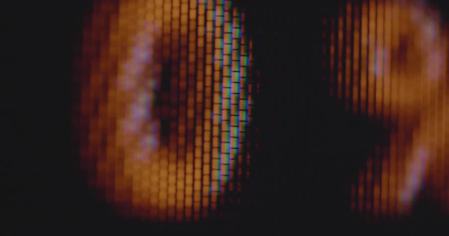 Dynamic handheld macro closeup of a retro tube television screen displays red and green figures numbers or digits in percentage that are increasing and decreasing causing stress and excitement as the end or deadline approaches and the time runs out