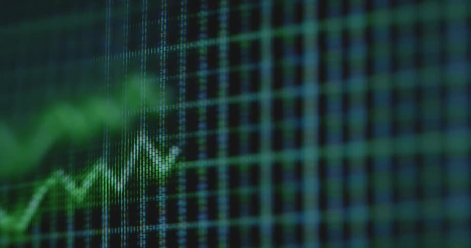Dynamic handheld macro shot of green rising trend line causing excitement and motivation to achieve financial freedom independence and success by earning money on the stock market and with crypto currency trading being displayed on a rgb pixel screen