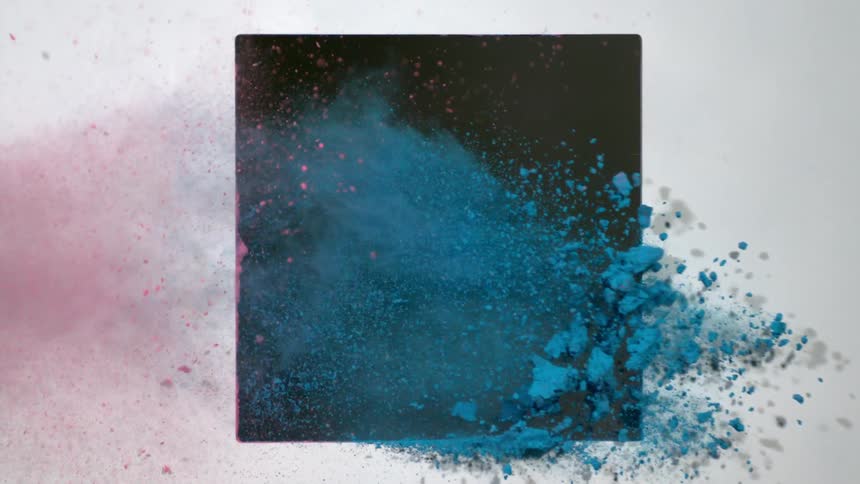 Red and blue dirt flies out of a black square