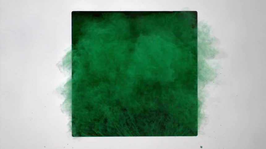 Green powder shooting out of a square hole in wall