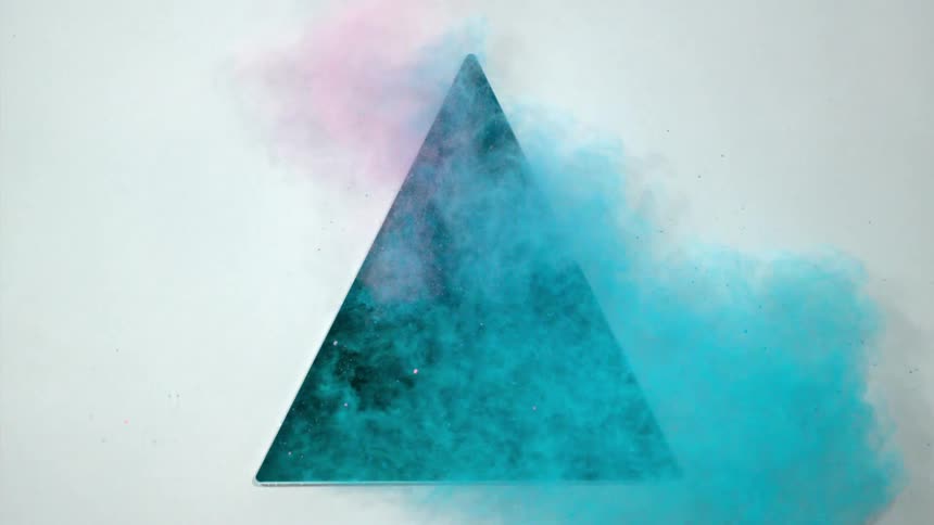Pink and blue dust pour out of a triangle