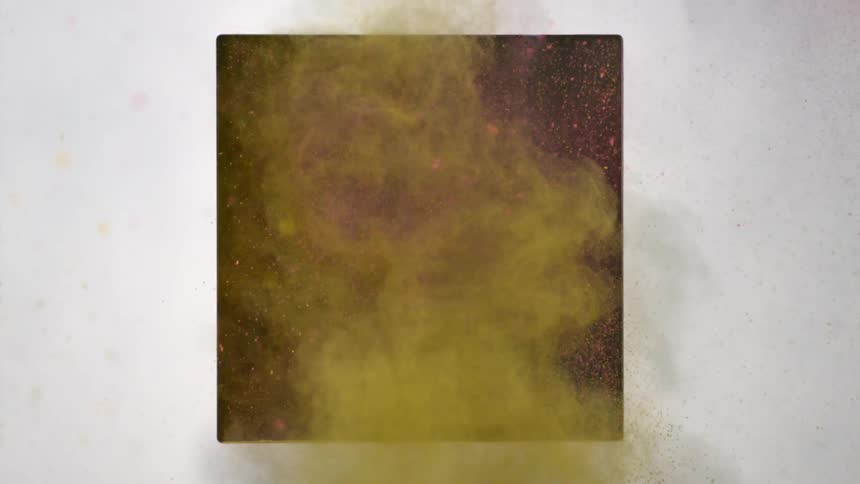 Yellow and pink dirt fly out of a black square