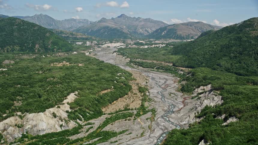  aerial footage of a scenic river with gray sediment flow in the North Fork Toutle River Washington on a sunny day in the Pacific Northwest during summer