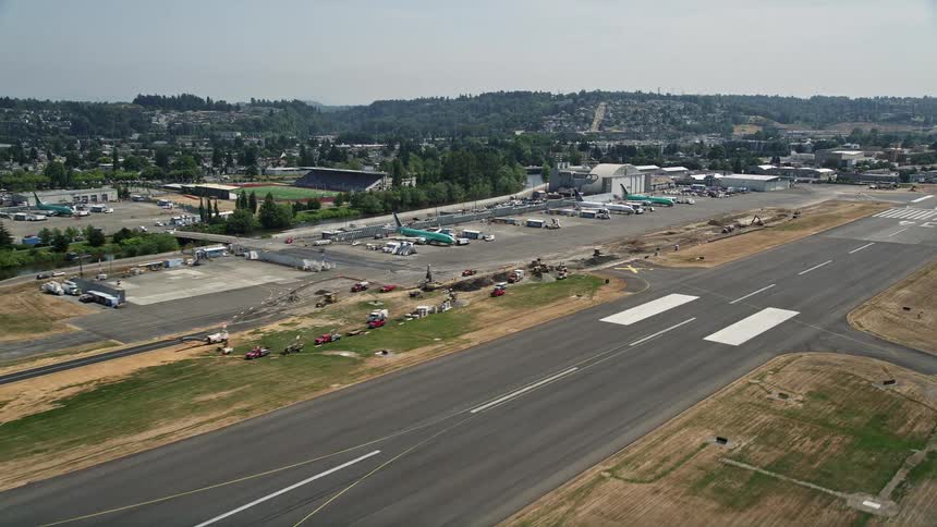 Aerial view of an airplane taking off from Renton Municipal Airport in Washington during a sunny day in summer