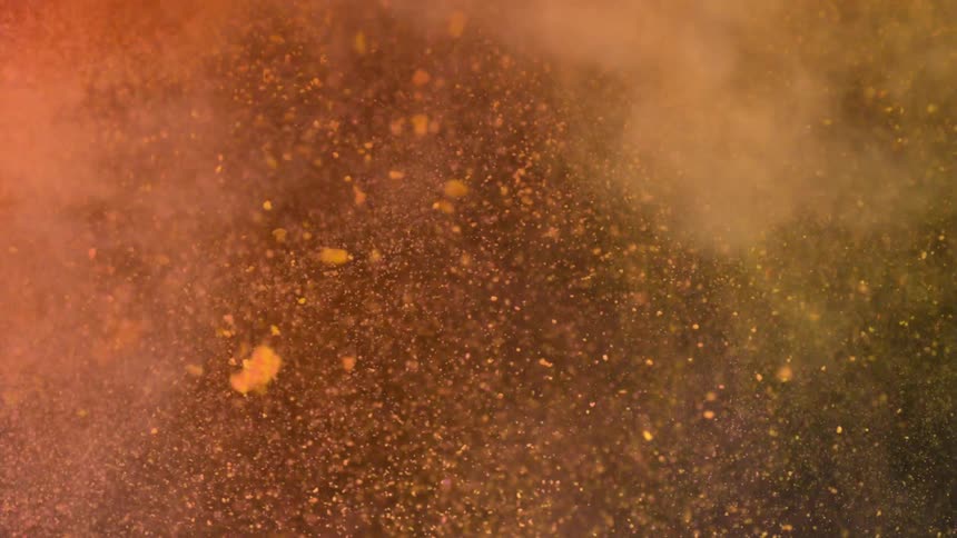 Yellow and pink dirt are thrown in the area