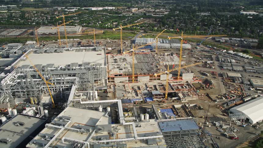 Aerial footage capturing the Intel Ronler Acres campus in Hillsboro Oregon during a sunny summer day showcasing the manufacturing plant and various areas under construction