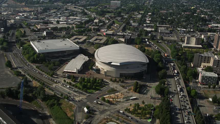 Aerial view of approaching the Moda Center a huge stadium in Northeast Portland Oregon from the Willamette River showcasing the urban cityscape and the vibrant energy of the surrounding area