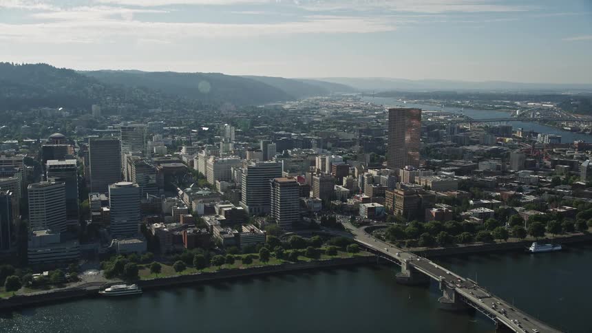 Aerial footage of downtown Portland Oregon captured from the Marquam Bridge revealing high-rise buildings and heavy traffic on the roadways below