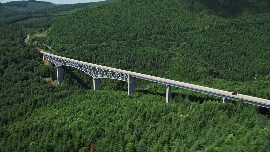 An SUV crosses the Spirit Lake Highway bridge in Cowlitz County Washington during a sunny day as seen in this aerial footage