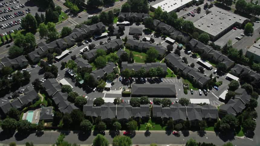 Aerial view of suburban homes and apartment buildings in Hillsboro Oregon with sunshine and clear skies