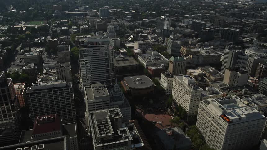 Aerial footage of a flyover the Morrison Bridge and Willamette River towards downtown Portland Oregon on a sunny day during summer