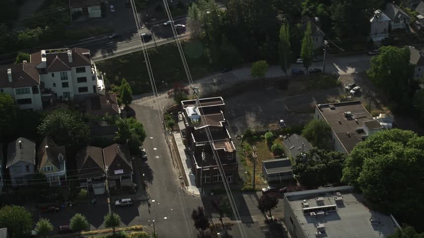 A 4K aerial footage capturing a gondola track over the bustling city streets of Southwest Portland Oregon on a sunny summer day
