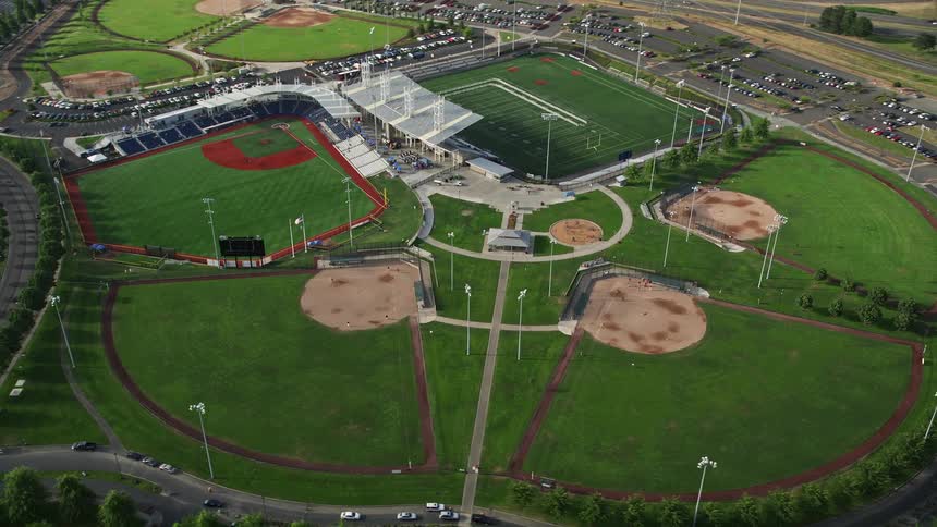 Aerial view of a vibrant and lively stadium with multiple field sections brightly illuminated in Hillsboro Oregon offering a vibrant sports venue
