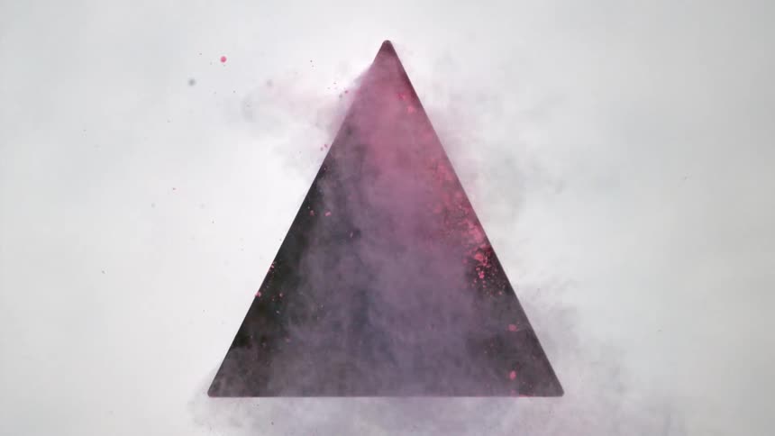 Pink dirt flies out of a black triangle