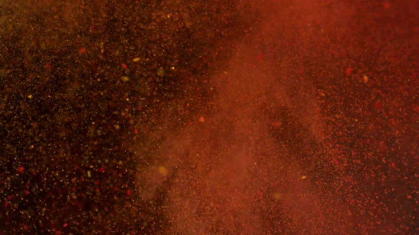 Yellow and bright red powders colliding