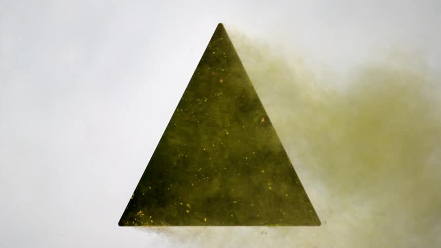 Yellow powder shooting out of a triangular hole in wall