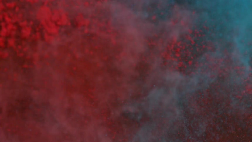 Blue and red dirt fly across each other