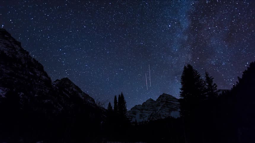 The sky is clear turning to many stars above a mountain range