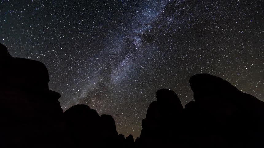 Star swirl in the sky above rocks