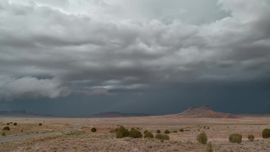 Several thunderbolts falling in a deserted place with a mountain in the background