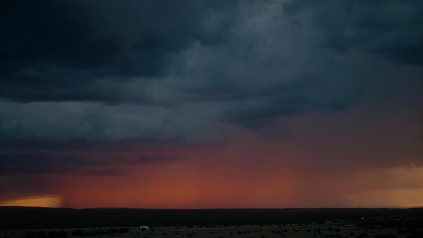 An lightning storm creating orange colors in the sky