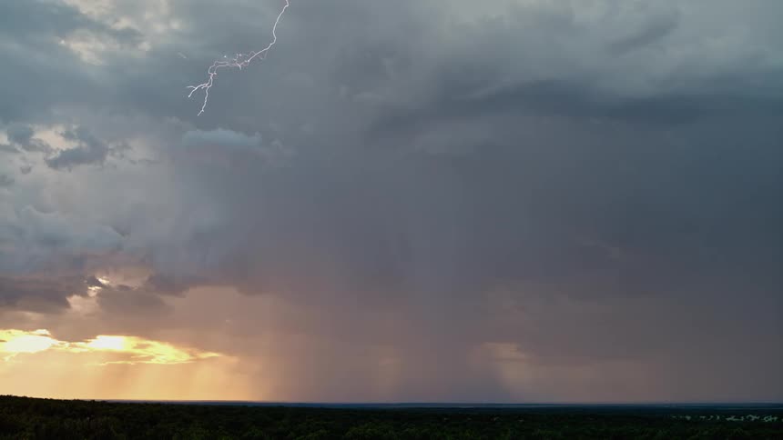 A stormy sky with lightning over a field