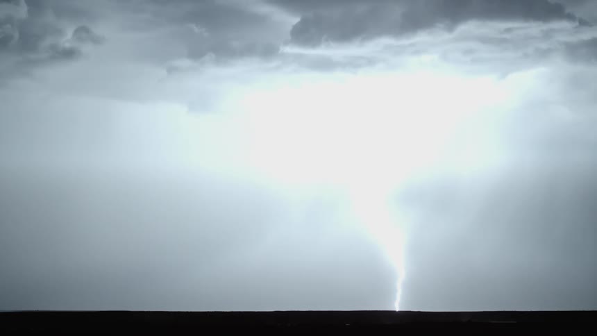 In the dark night lightening strike revealing the cloudy sky