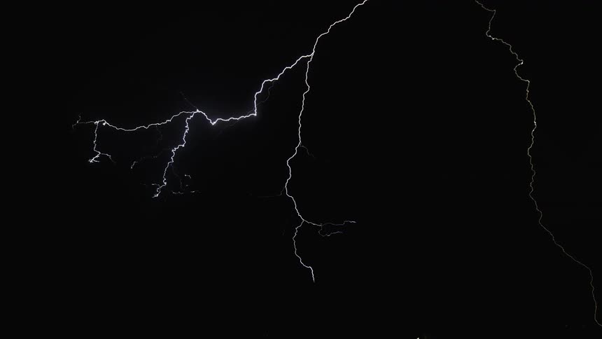 In the dark night lightening strike revealing the bushes and grasses
