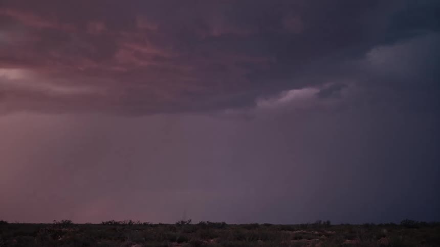 Lightning bolts striking out of the storm covered sky onto a flatland below