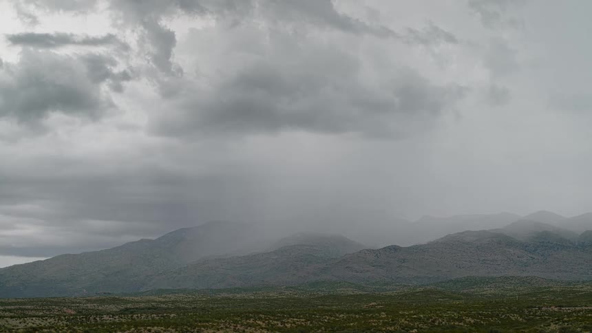White thunder in cloudy sky and green mountains