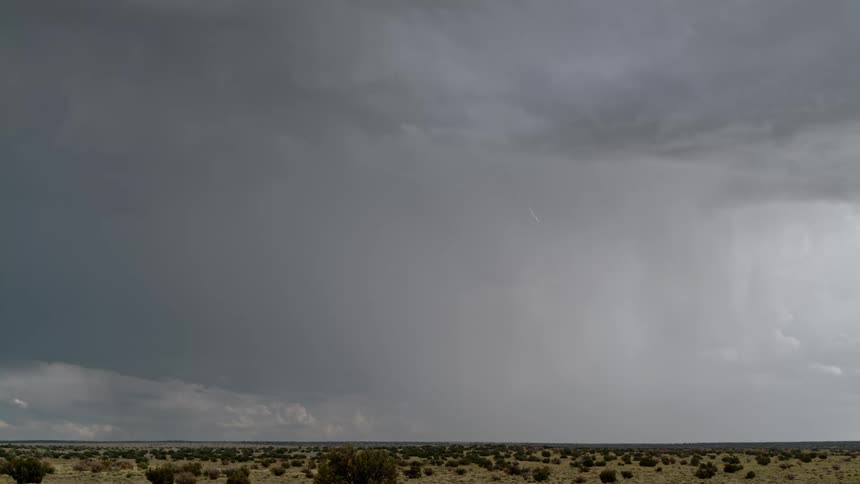 On a cloudy day thunder and lightning electrify the desert landscape