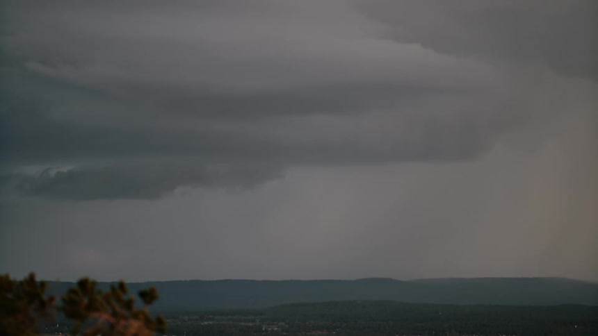 A dark and stormy sky with a lot of lightning in the desert