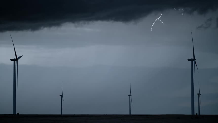 In the evening thunder and lightning stroke in a windmill as the sky remain cloudy
