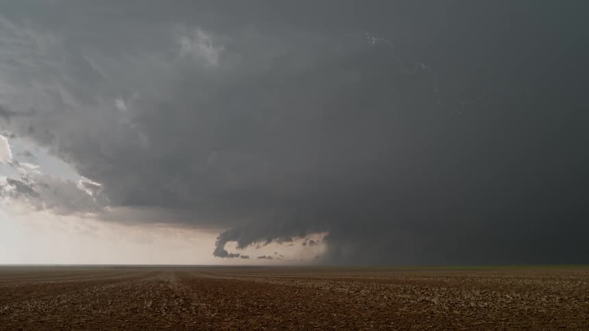 Dark clouds with heavy thunderstorms over an agricultural region