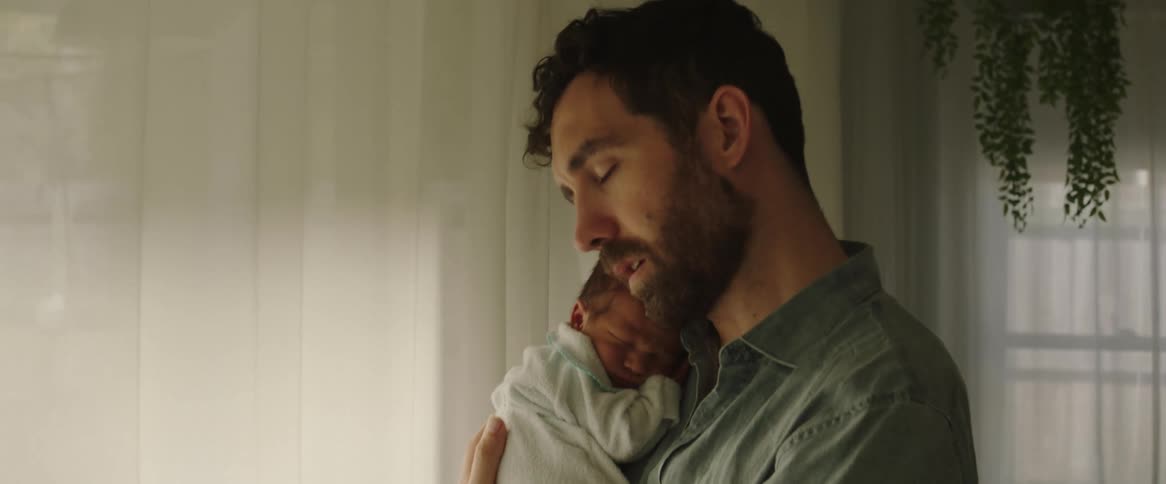 Father cradling his newborn son