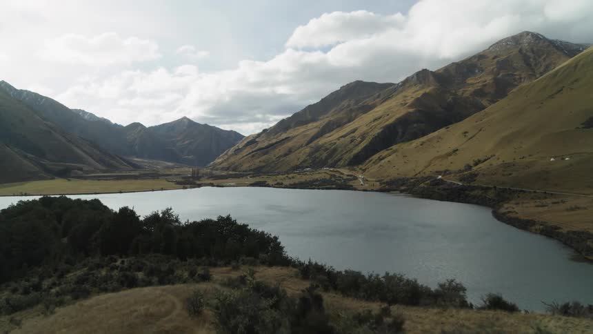 Landscape of a river and mountains with a man in the background