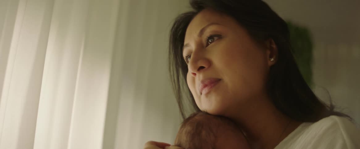 Woman with a baby in her arms stroking
