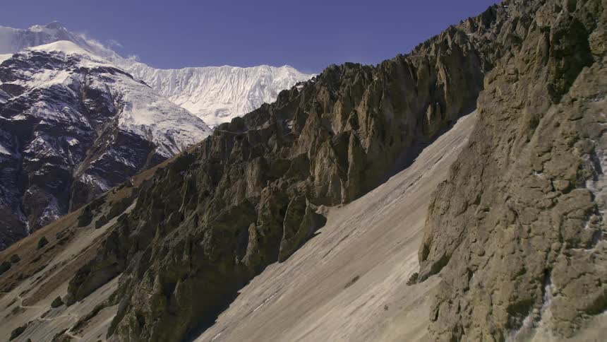 Aerial view of a mountain side covered in rocky formations