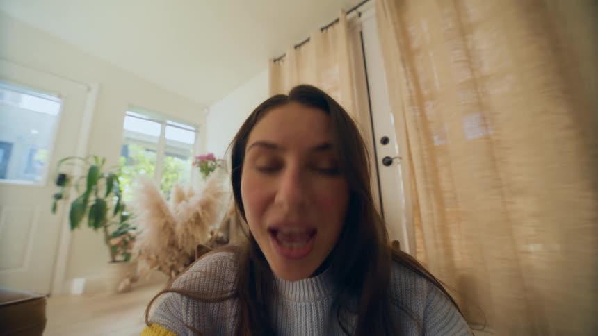 Mother sits on floor and smiles while saying i love you