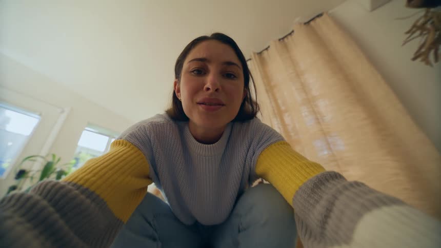 Woman smiling while sitting on a chair in a room