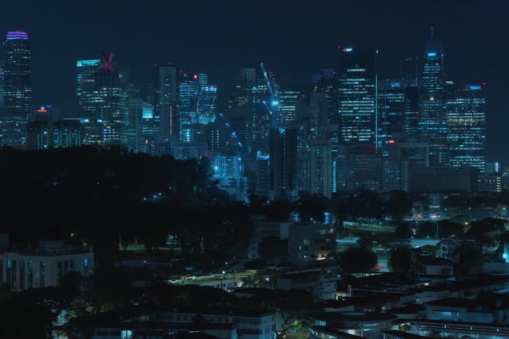 A time lapse shows multiple sky scrapers being constructed at night