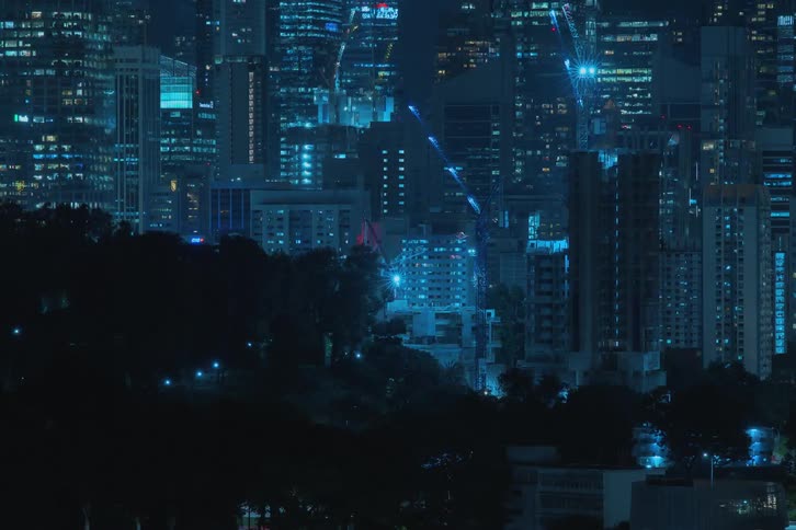 A time lapse of buildings in a city raising with bright lights shining from them