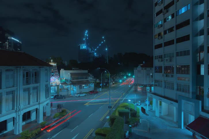 A time lapse of a city intersection as cars pass through it and buildings on either side