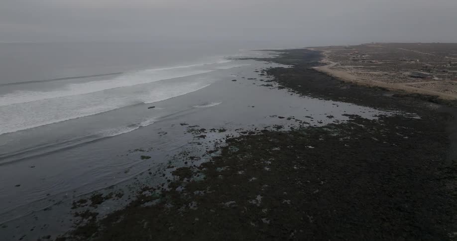 Calm ocean with small ripples on a cloudy day