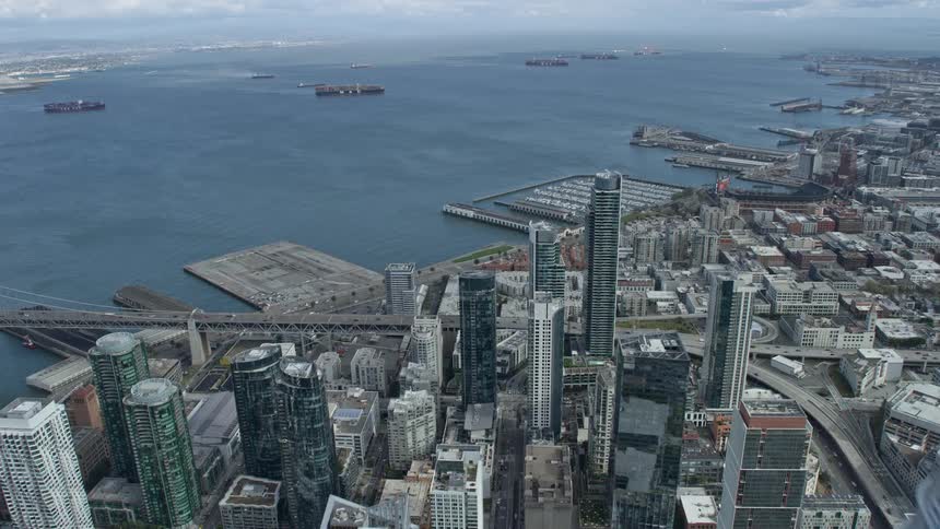  aerial stock footage of a fly past Salesforce Tower in downtown San Francisco with a tilt towards South of Market skyscrapers showcasing the high rise buildings and cloudy skies of the city