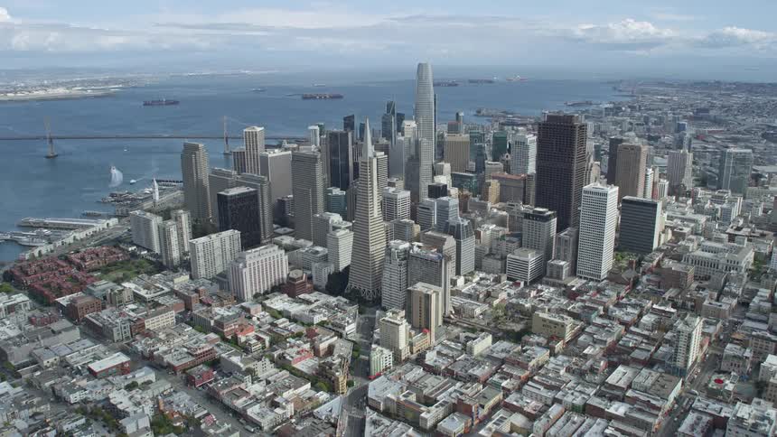 Aerial footage showcasing the approach to Salesforce Tower in Downtown San Francisco California with cloudy skies and a wide-angle perspective