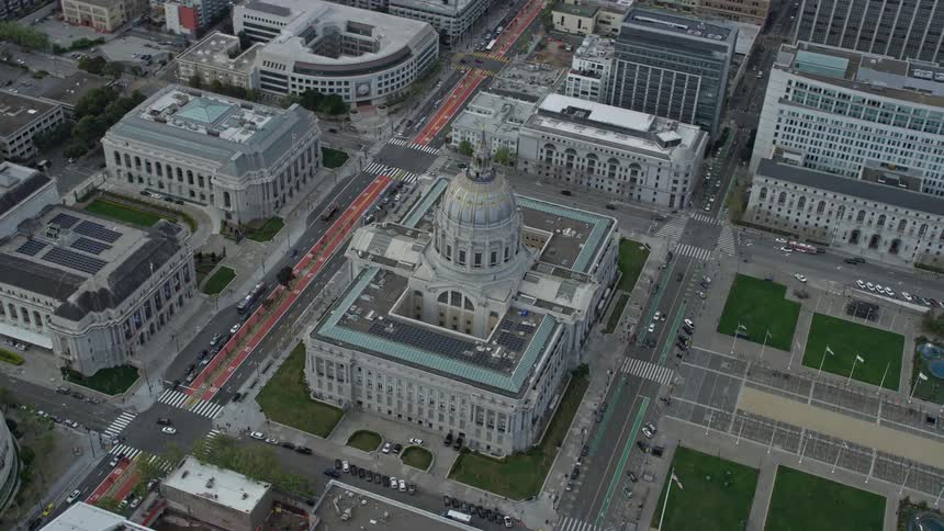 Aerial view of San Francisco City Hall in the Civic Center district filmed on a cloudy day approaching from a side view