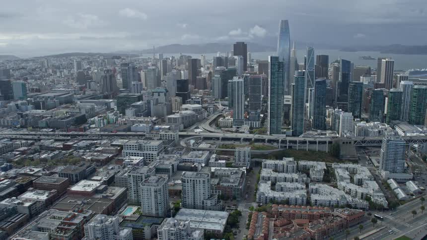 Tilt up aerial view of Salesforce Tower and downtown San Francisco California approached from the South of Market on a cloudy day
