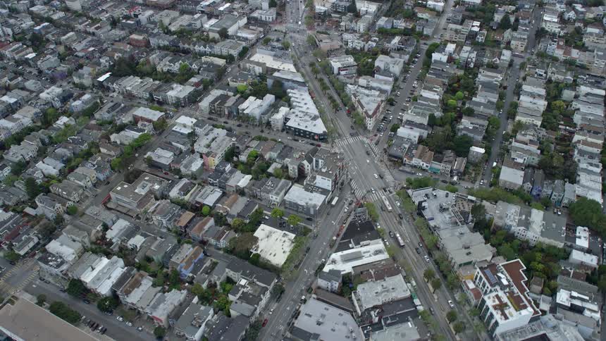  aerial footage captures the bustling traffic passing through a six-way intersection in the residential area of San Francisco's Castro District on a cloudy day in the Bay Area